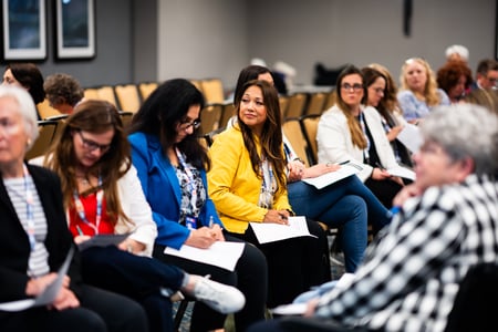 women taking notes in speaking workshop